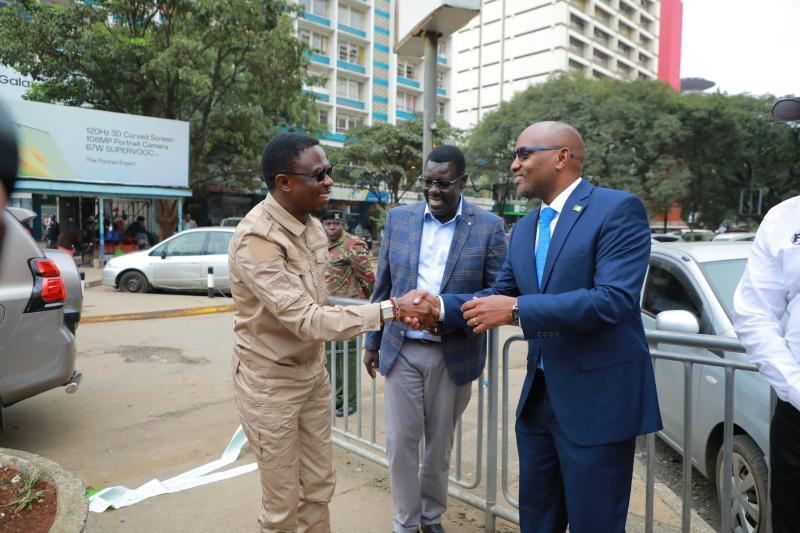 Sports CS Ababu Namwamba greets KCB CEO, Paul Russo.